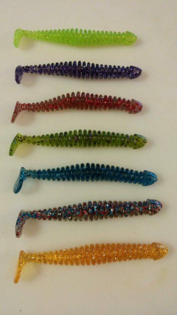 From top to bottom: Green Chartreuse, Purple Fleck, Red Smoke Glitter, Baby Bluegill, Oyster, Old Glory, and Goldmember.